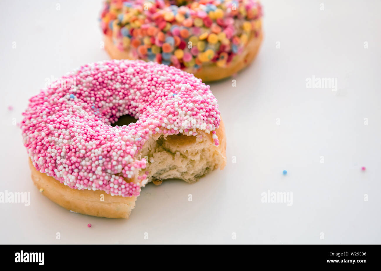 Delicious donuts. Pink and pastel colors decoration on white color background, copy space, closeup view Stock Photo