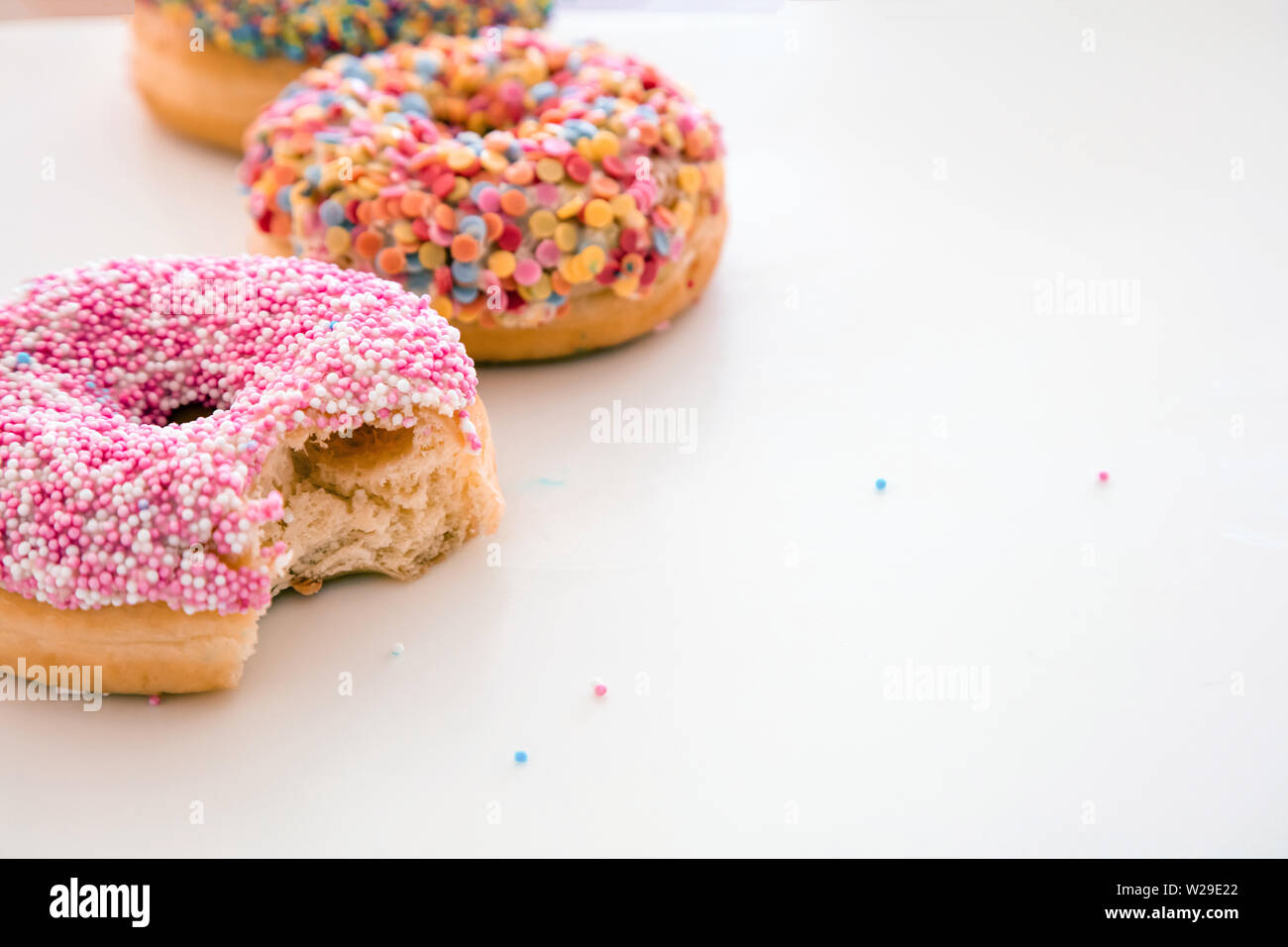 Delicious donuts. Pink and pastel colors decoration on white color background, copy space, closeup view Stock Photo