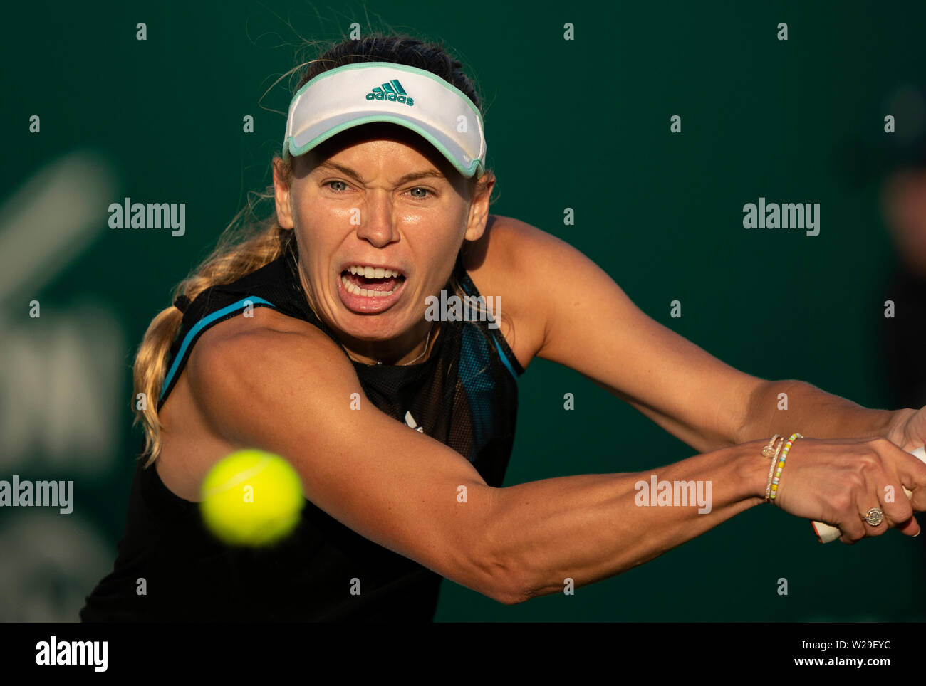 Caroline Wozniacki of Denmark playing two handed backhand against Arena Sabalenks of Belarus. Caroline Wozniacki at Nature Valley International 2019, Stock Photo