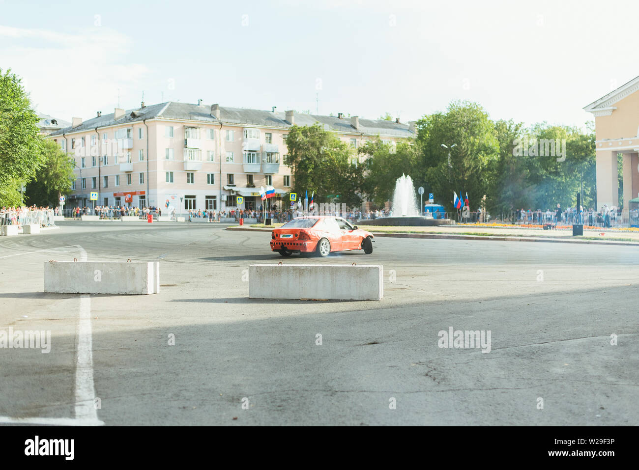 Samara Russia - 07.05.19 Youth Day in Russia. People in the square look like a car drift on the roads. Smoke from under the tires of a red car. Stock Photo