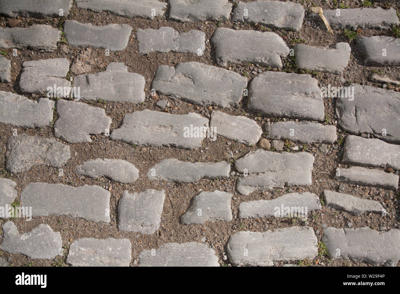 old vintage cobbled road texture background Stock Photo - Alamy