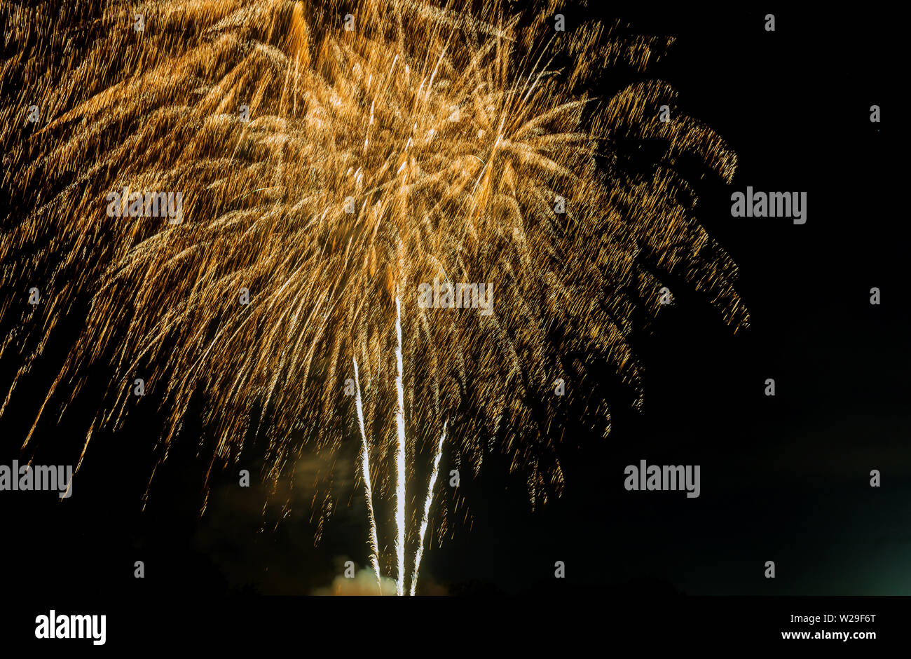 4th July fireworks gold glittering sparkle fireworks display on dark