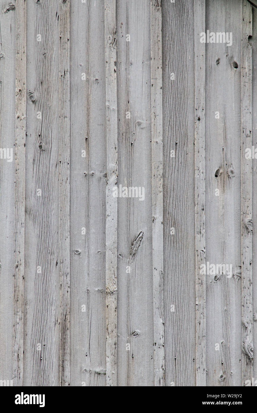 Textured Grain Barn Wood Background. Grey weathered wooden barn wall background in vertical orientation. Stock Photo