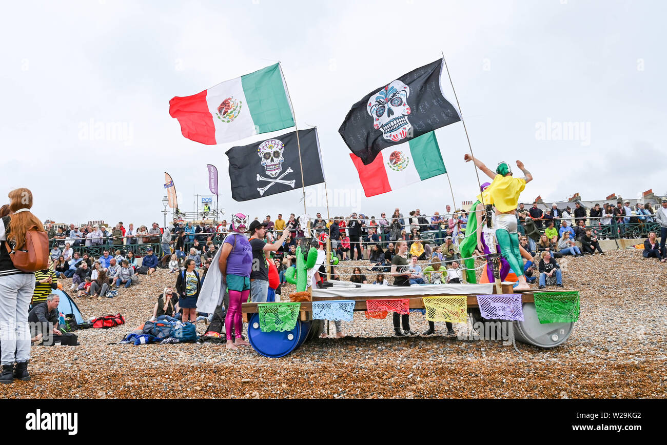 Brighton UK 7th July 2019 -  Competitors  prepare for this years Paddle Round the Pier beach festival in Brighton . The annual Paddle Round the Pier is now the largest free beach festival in Europe raising money for various charities including Surfers Against Sewage  . Credit : Simon Dack / Alamy Live News Stock Photo