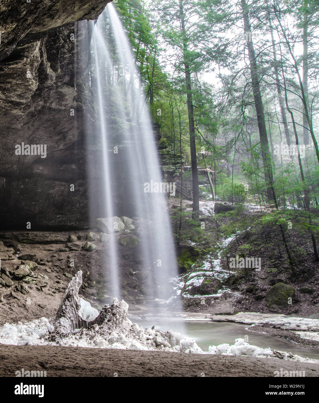 Ohio Nature Landscape In Vertical Orientation. Springtime arrives to Hocking Hills State Park as snow begins to melt. Stock Photo