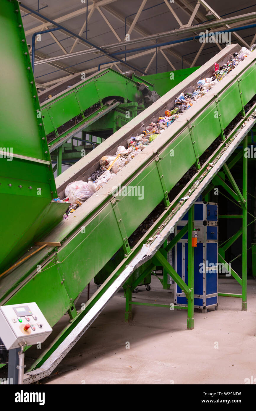 Waste processing plant. Technological process for acceptance, storage, sorting and further processing of waste for their recycling. Selective focus. T Stock Photo