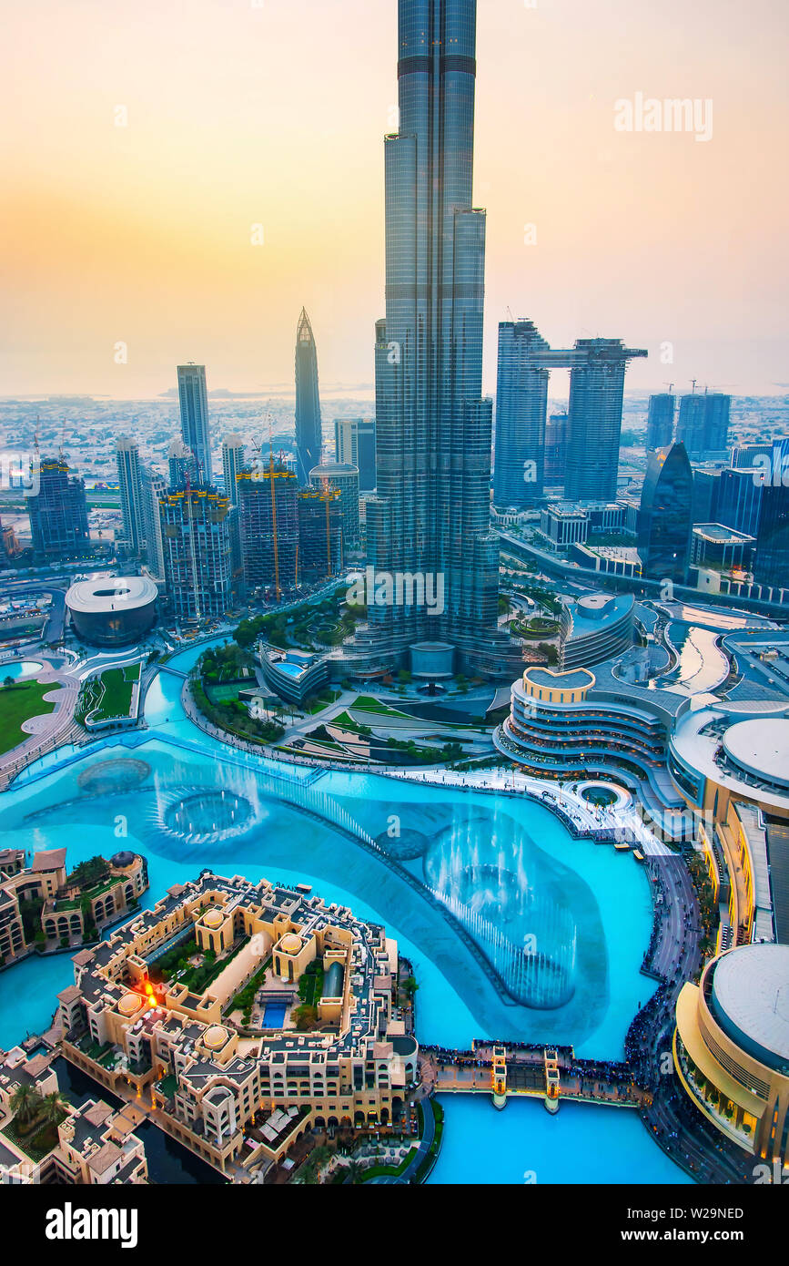 Dubai, United Arab Emirates - July 5, 2019: Burj khalifa rising above Dubai mall and fountain surrounded by modern downtown buildings top view Stock Photo
