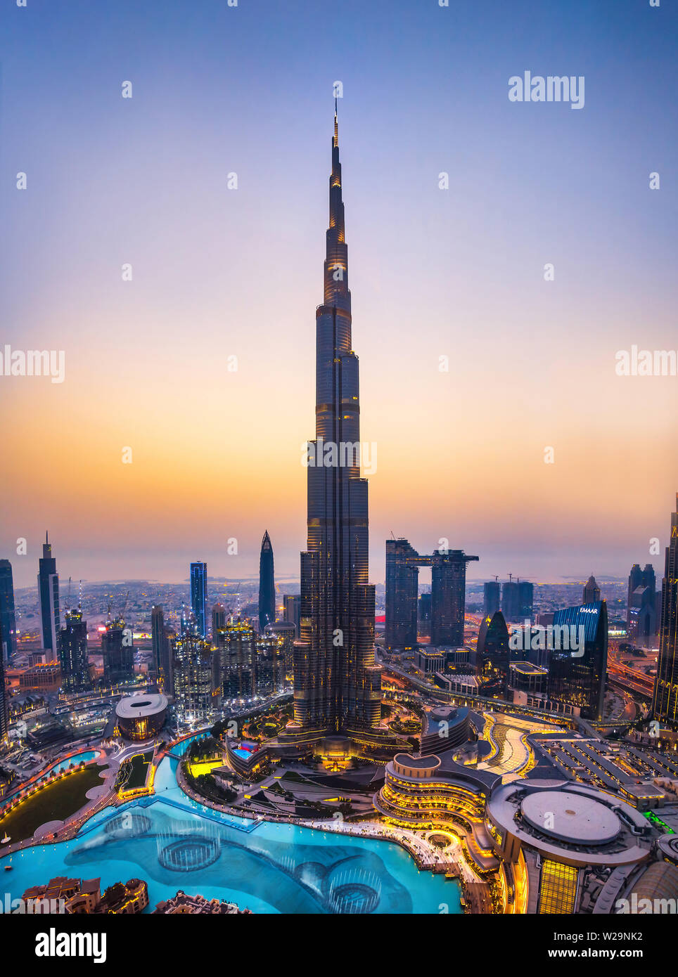 Dubai, United Arab Emirates - July 5, 2019: Burj khalifa rising above Dubai mall and fountain surrounded by modern downtown buildings top view Stock Photo