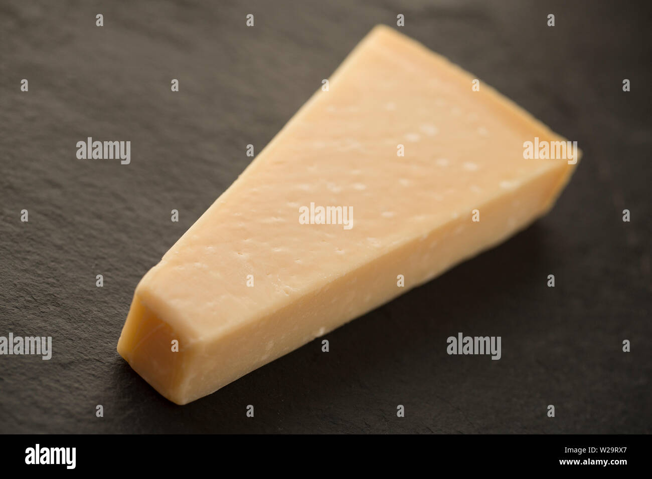 A wedge of Parmigiano Reggiano Parmesan cheese imported from Italy and