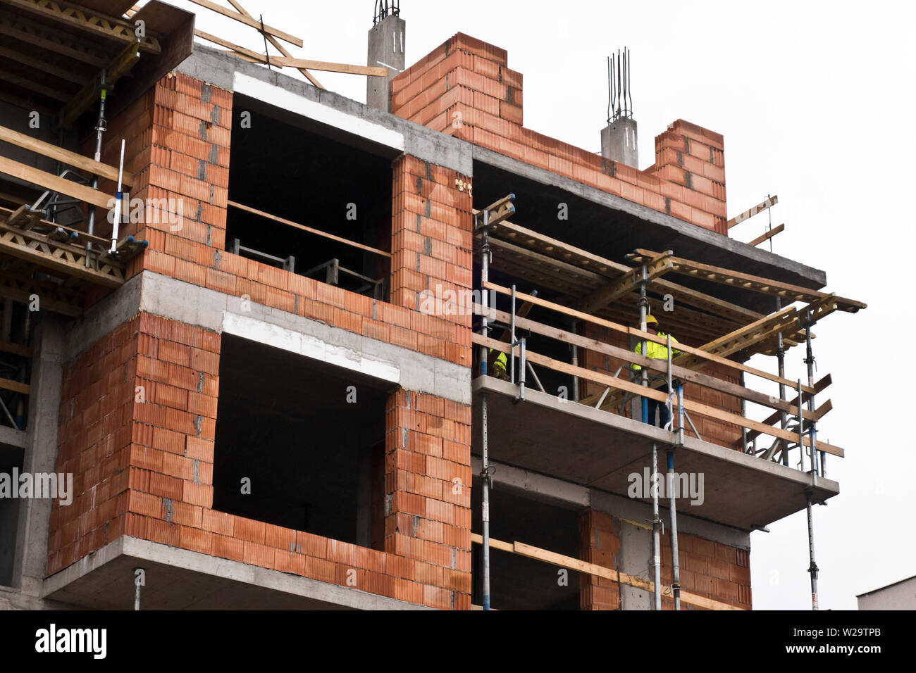 construction laborers during the built of a new residential multi-storey building Stock Photo