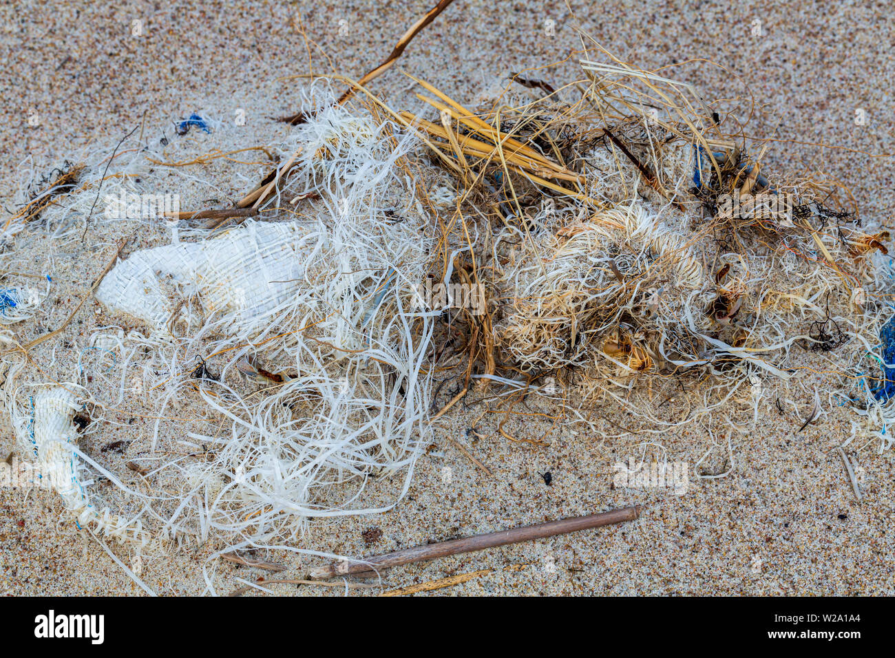 Environmental pollution - a ball of plastics on a beach Stock Photo