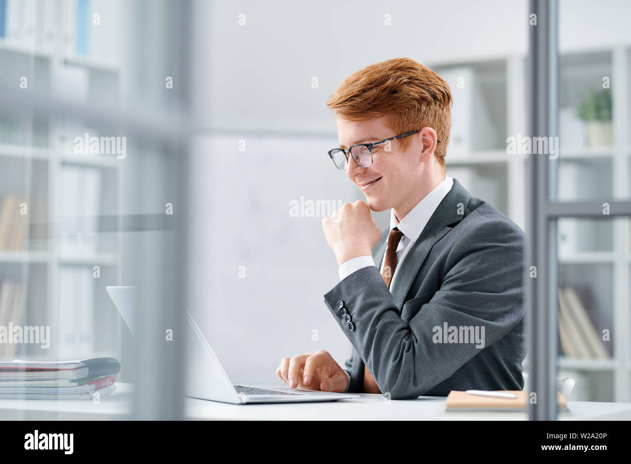 Young successful analyst or financier working with online data Stock Photo
