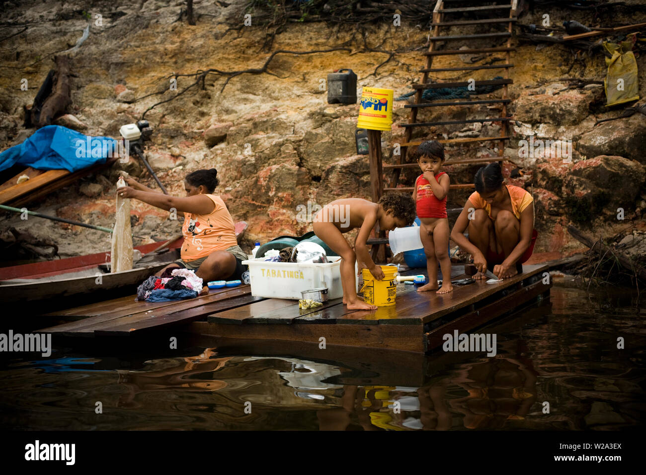 People Washing Clothes in River, Nova Canaã Community, Cuieiras River, Amazônia, Manaus, Amazonas, Brazil Stock Photo