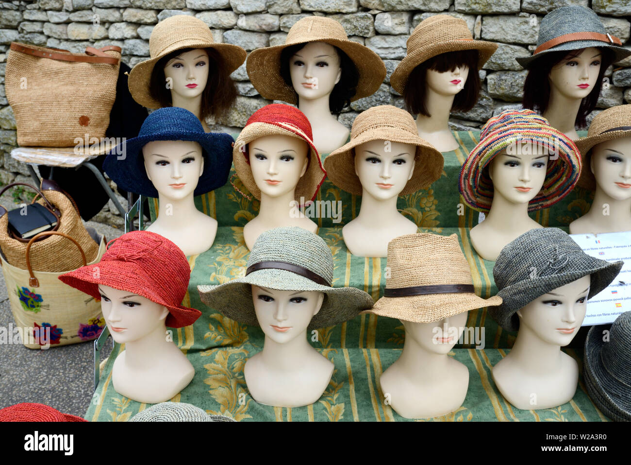 Straw Hats or Raphia Hats Hat Display on Dummy Heads or Mannequins on Market Stall Bonnieux Luberon Provence Stock Photo