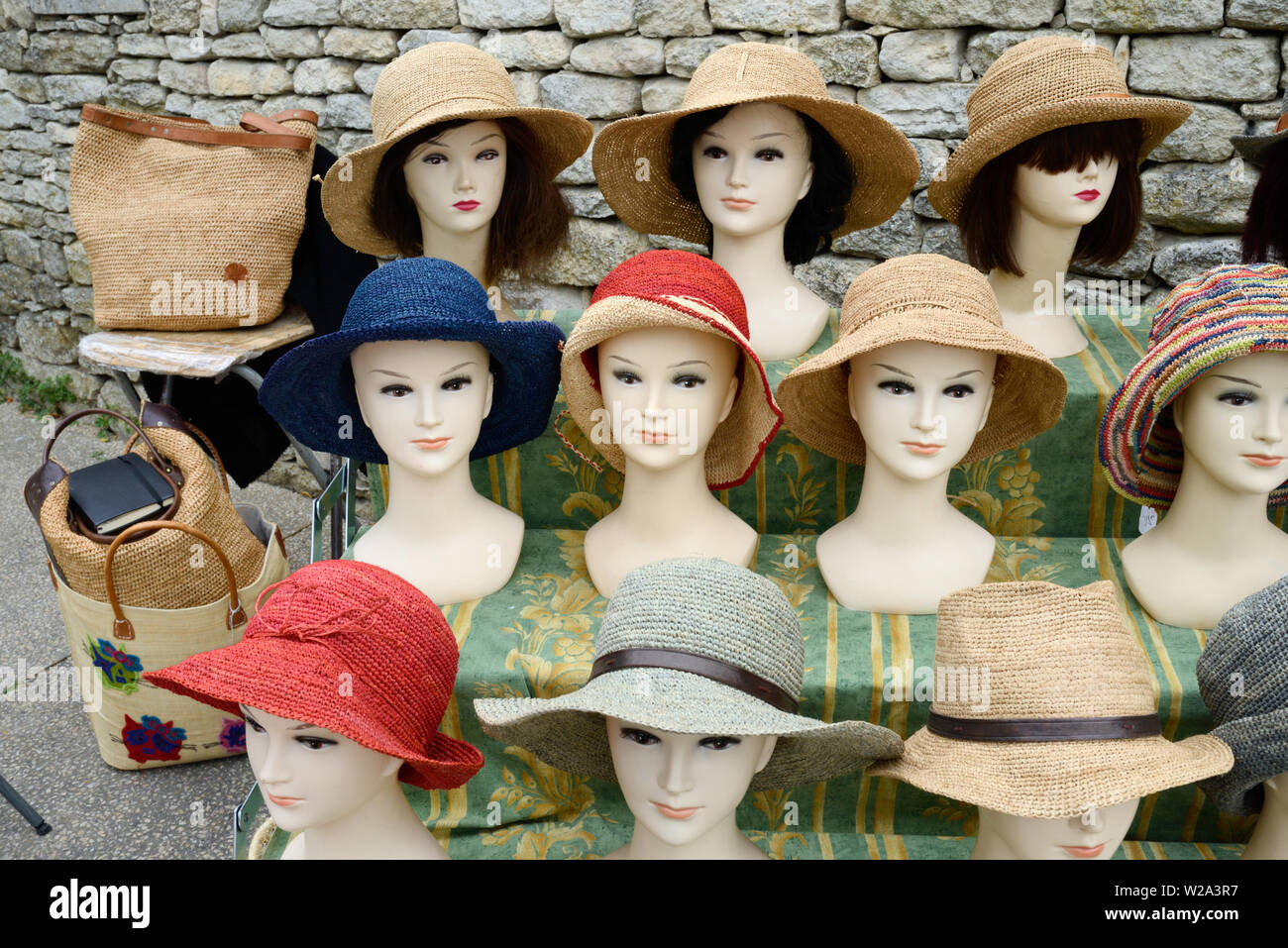 Straw Hats or Raphia Hats Hat Display on Dummy Heads or Mannequins on Market Stall Bonnieux Luberon Provence Stock Photo