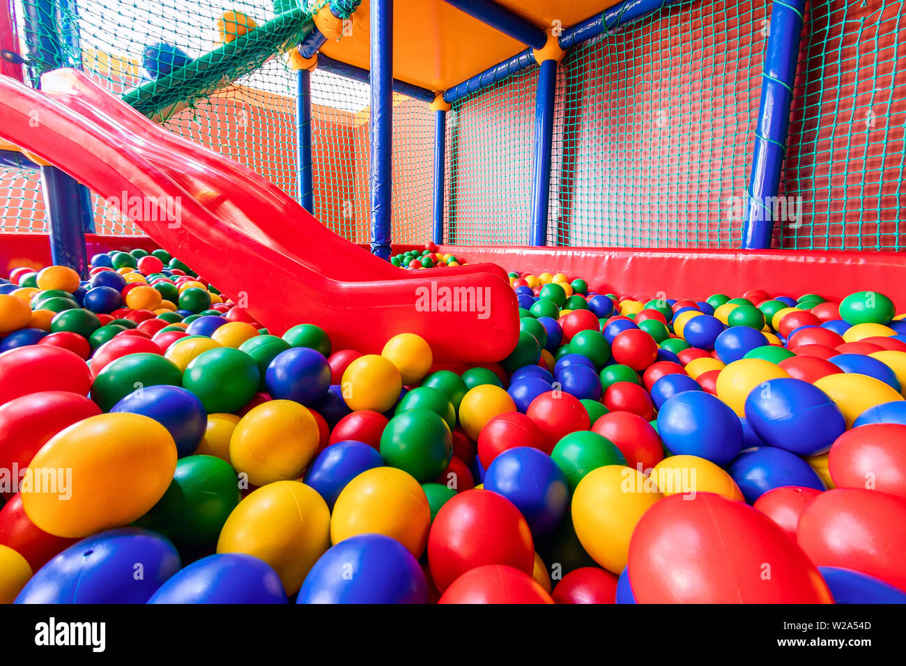 Colored plastic balls in pool of game room. Swimming pool for fun and