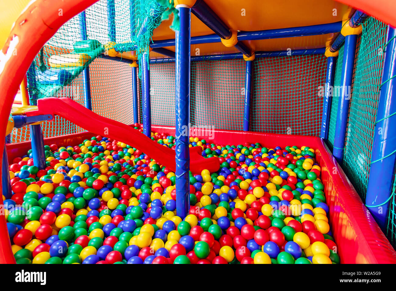 Colored plastic balls in pool of game room. Swimming pool for fun and  jumping in colored plastic balls Stock Photo - Alamy