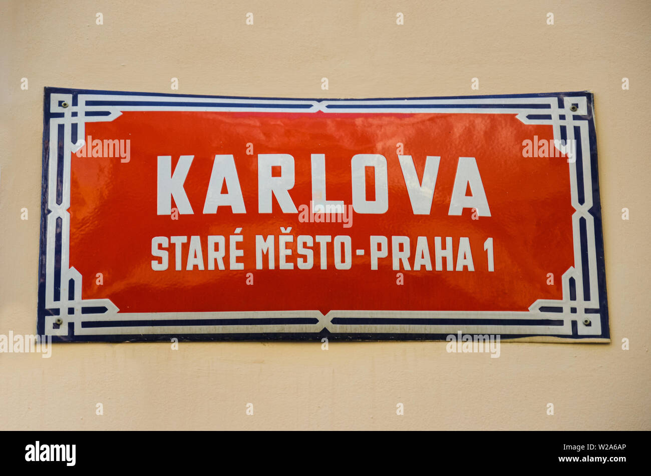 Red street sign in Prague, Czech Republic with white text Karlova