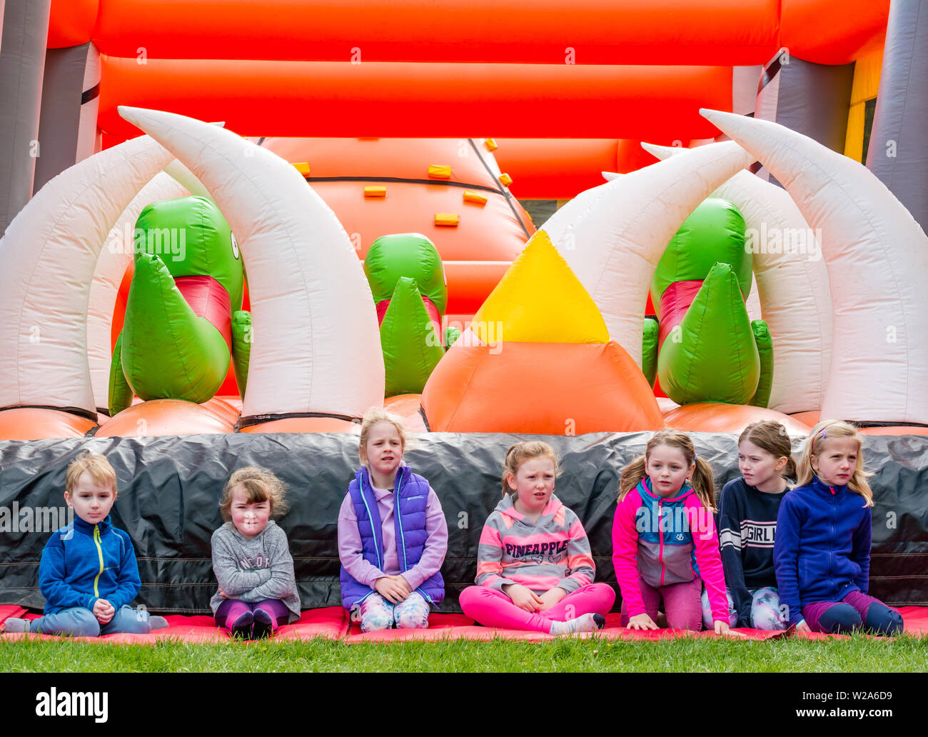 Labyrinth Challenge, Dalkeith Country Park, Midlothian, Scotland, UK.  Children wait patiently for opening of world's longest inflatable obstacle course Stock Photo