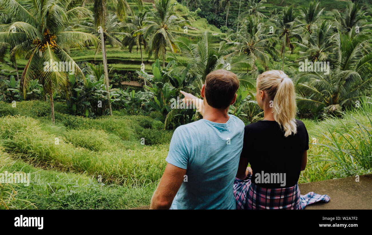 Happy couple explore Tegalalang rice terraces near Ubud, Bali, Indonesia. Summer travel vocation concept Stock Photo