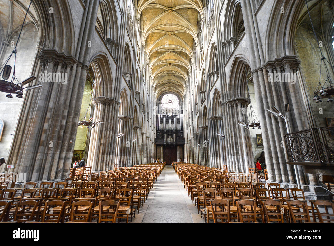 The nave on the interior of the Cathedral of Rouen France with the Rose Window behind in Rouen France Stock Photo