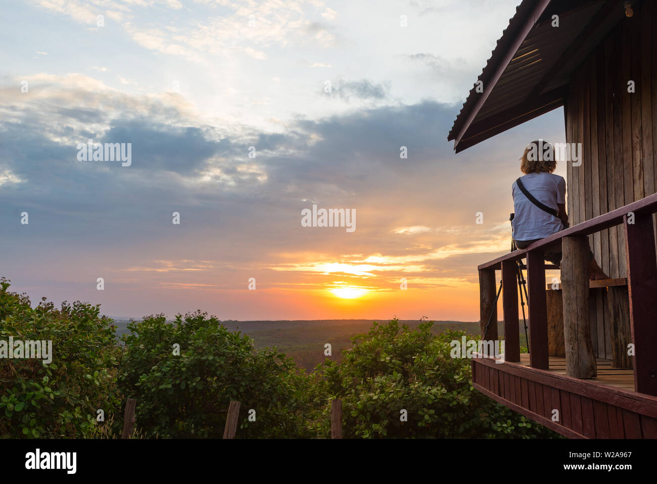 Woman watching sunset balcony hi-res stock photography and images - Alamy