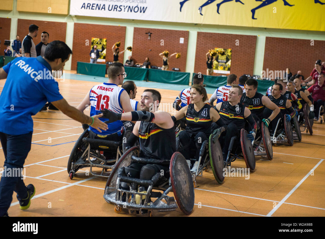 Players greet each other with hi-fives, after the game.The French National Team beat the Germans, 42:47 during the final and won the Metro Cup for the second time. The Metro Cup is the largest international Wheelchair Rugby Tournament in Poland. On 4-6 July 2019, the seventh edition of this event was held at the Ursynów Arena in Warsaw. Wheelchair rugby is a Paralympic sports discipline for people with spinal cord injury in the cervical segment and people with leg disorders. Stock Photo