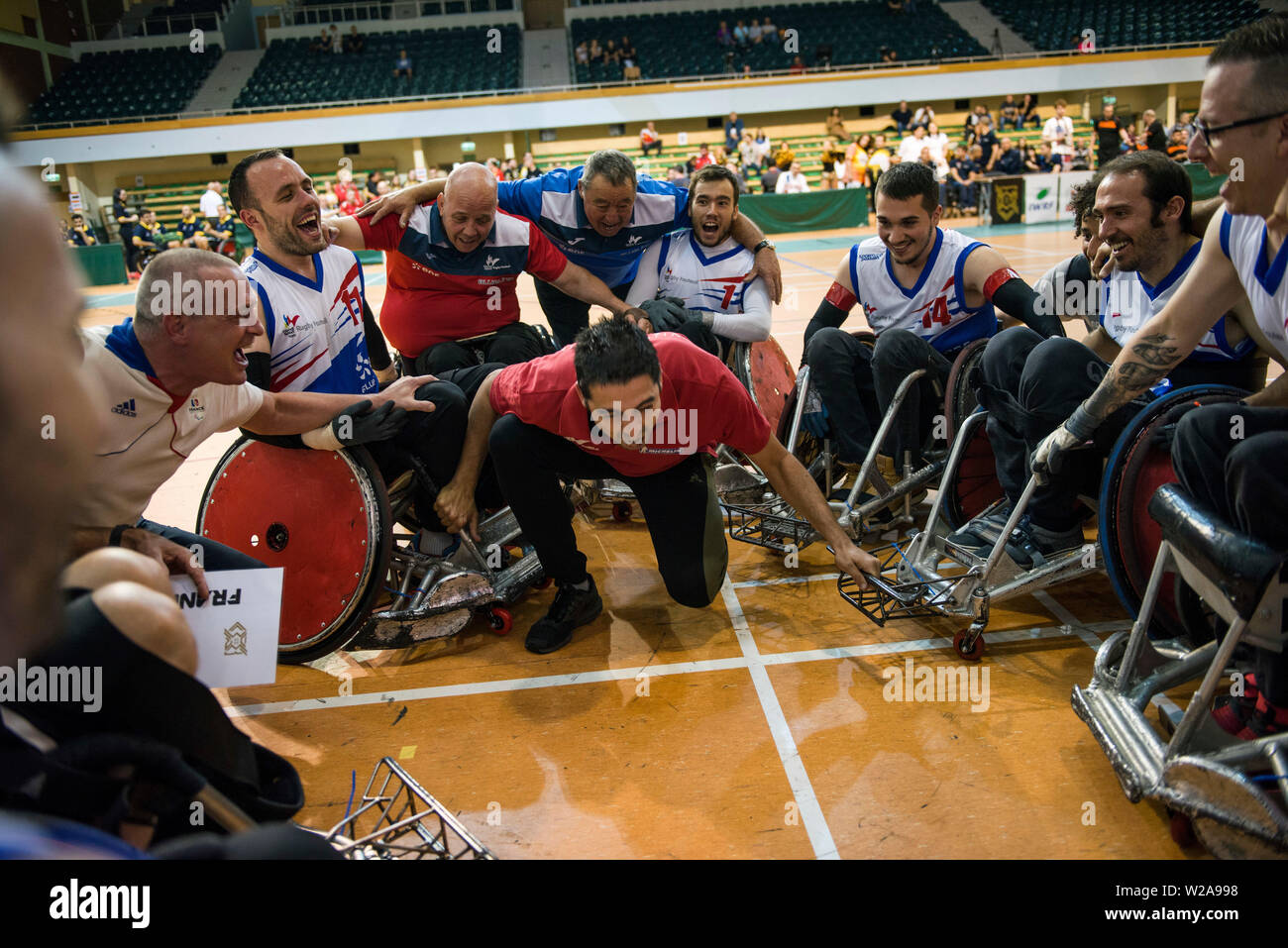 French players shout and sing after they won the game.The French National Team beat the Germans, 42:47 during the final and won the Metro Cup for the second time. The Metro Cup is the largest international Wheelchair Rugby Tournament in Poland. On 4-6 July 2019, the seventh edition of this event was held at the Ursynów Arena in Warsaw. Wheelchair rugby is a Paralympic sports discipline for people with spinal cord injury in the cervical segment and people with leg disorders. Stock Photo