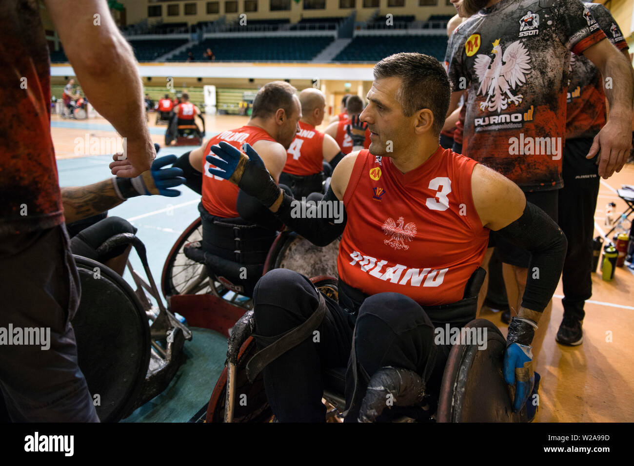 Players greet each other with hi-fives, after the game.The French National Team beat the Germans, 42:47 during the final and won the Metro Cup for the second time. The Metro Cup is the largest international Wheelchair Rugby Tournament in Poland. On 4-6 July 2019, the seventh edition of this event was held at the Ursynów Arena in Warsaw. Wheelchair rugby is a Paralympic sports discipline for people with spinal cord injury in the cervical segment and people with leg disorders. Stock Photo