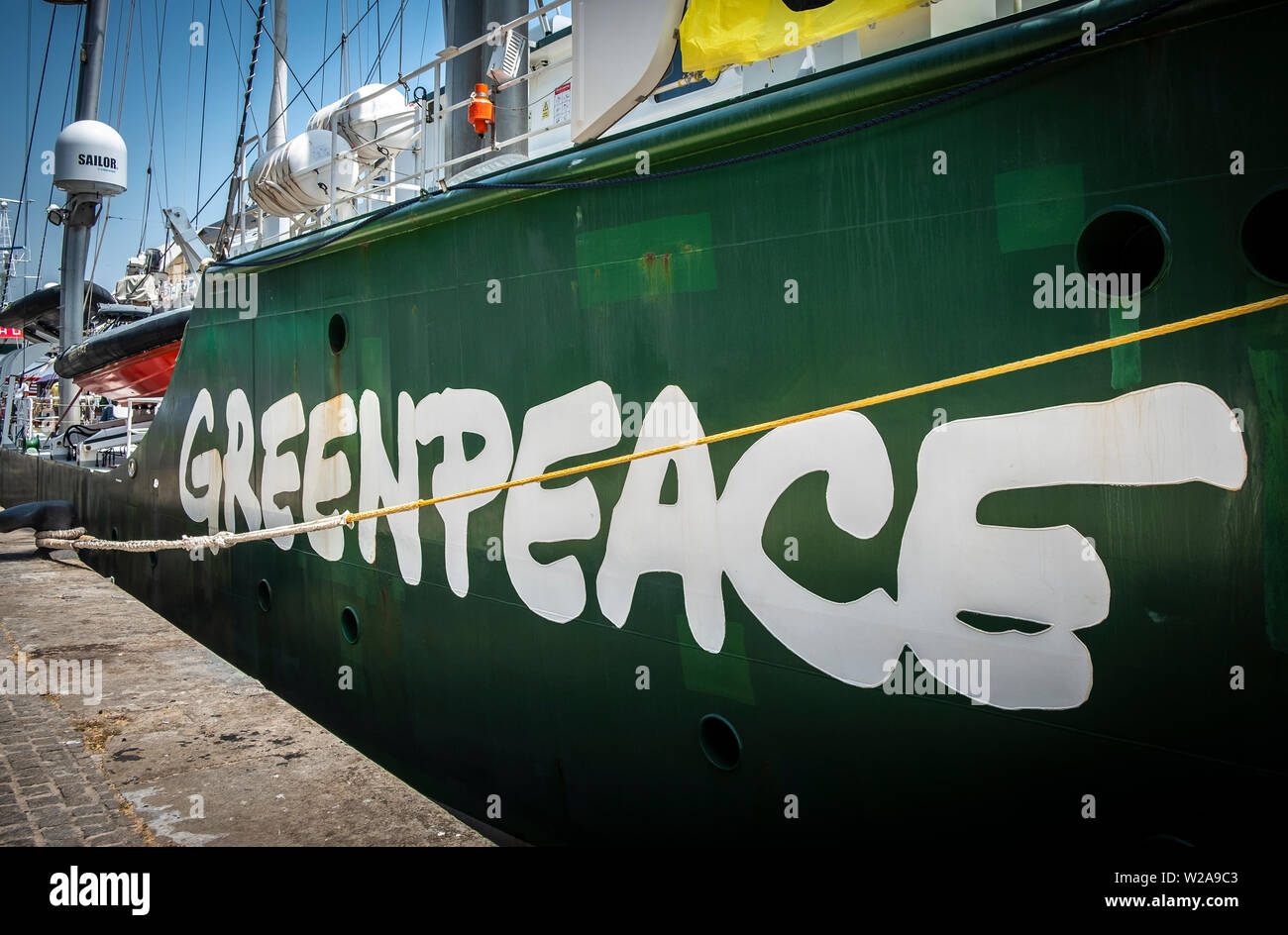 The ship Rainbow Warrior is moored at the port of Barcelona.The flagship Rainbow Warrior of Greenpeace arrives in Spain to fight against the climate crisis. The sailboat will stop at the ports of Barcelona, Malaga and Vigo to demand urgent measures against the climate crisis. Stock Photo