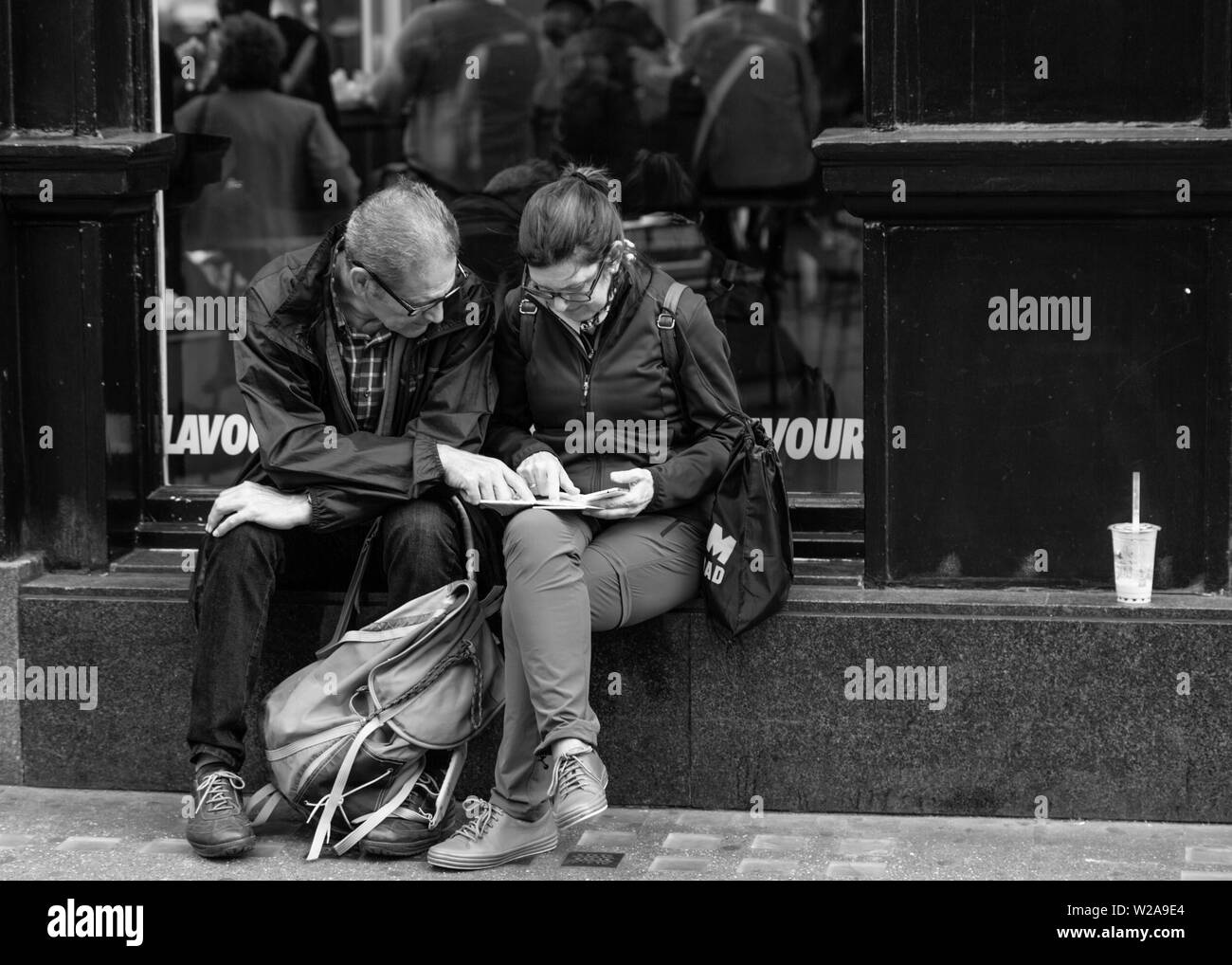 London street travel couple looking at the map Stock Photo