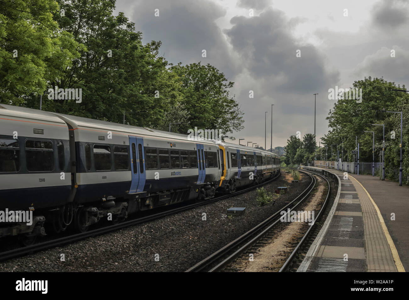 Moving train from station at Hither Green Stock Photo