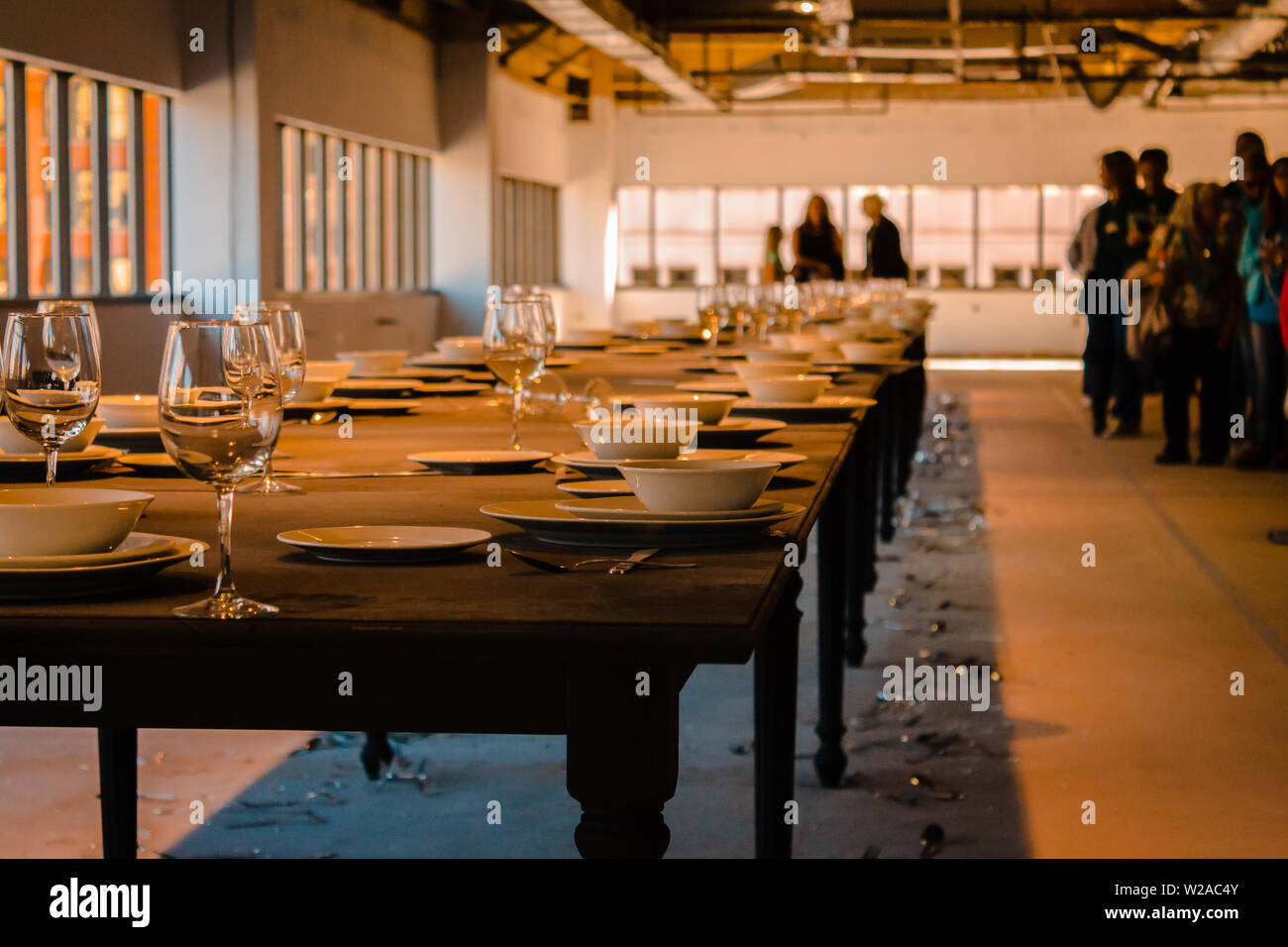 Art entry where whispers vibrate a table and break the place settings Stock Photo