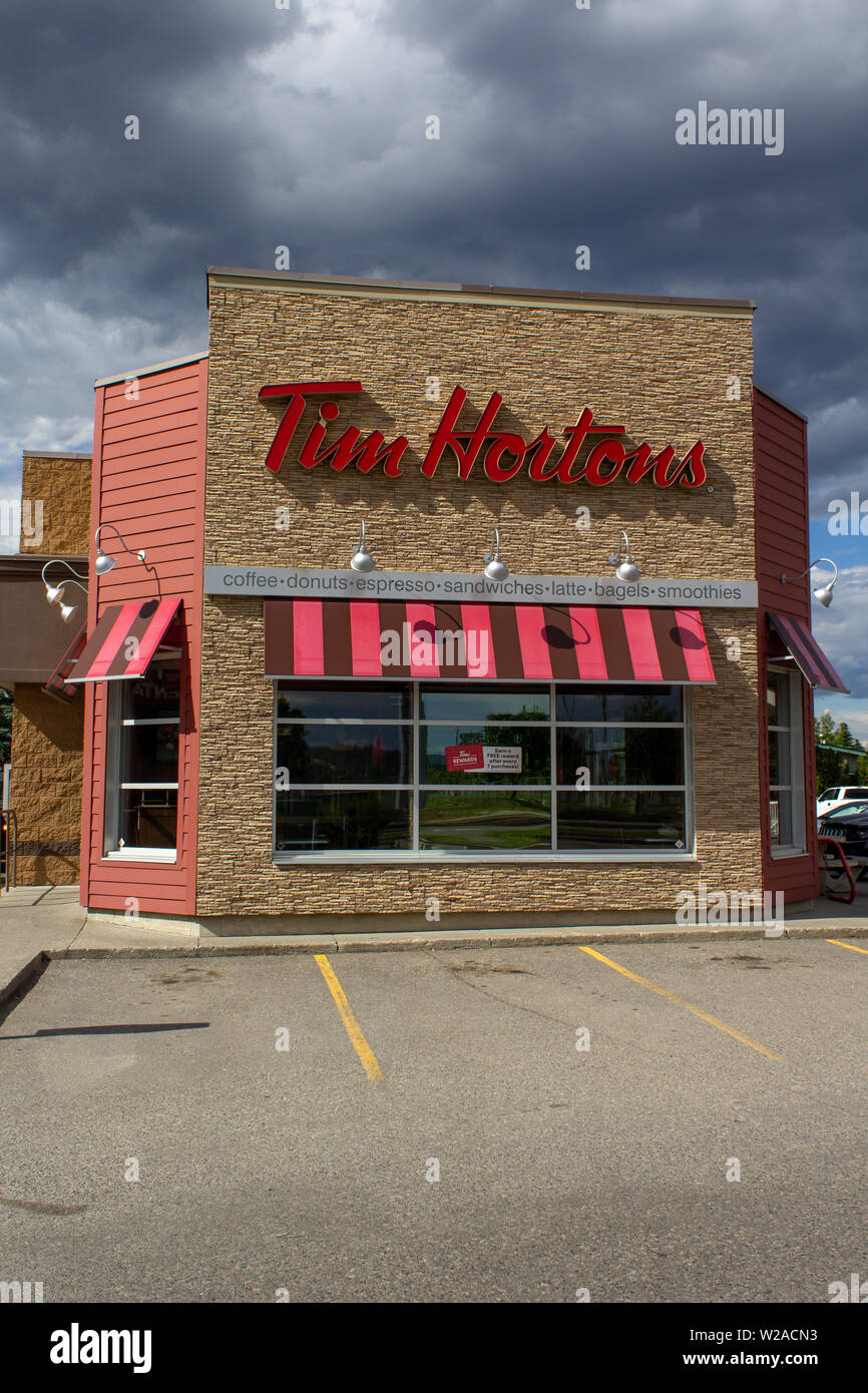 MONTREAL, CANADA - NOVEMBER 6, 2018: Tim Hortons Logo In Front Of One Of  Their Restaurants In Quebec With Their Slogan In French In The Background. Tim  Hortons Is A Cafe And