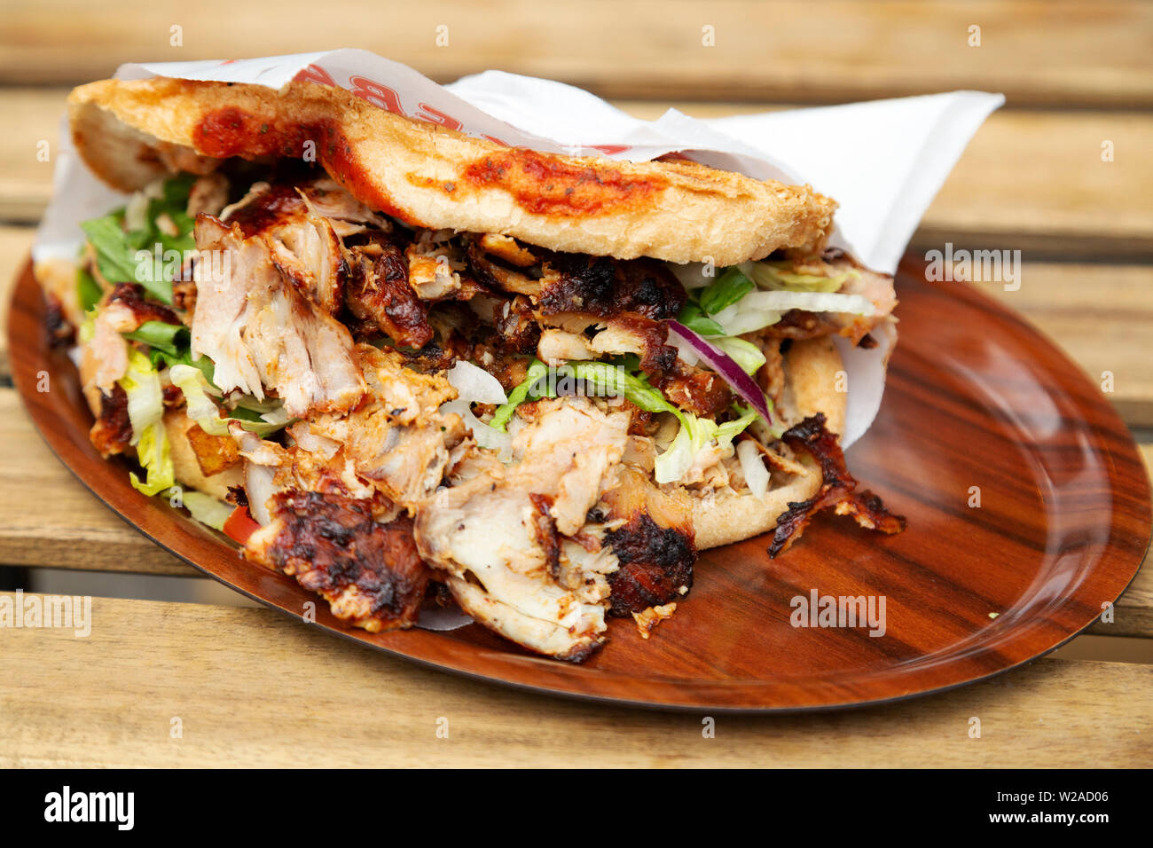 A lamb doner kebab served in Berlin, Germany. The kebab is served in a bread bun with salad and