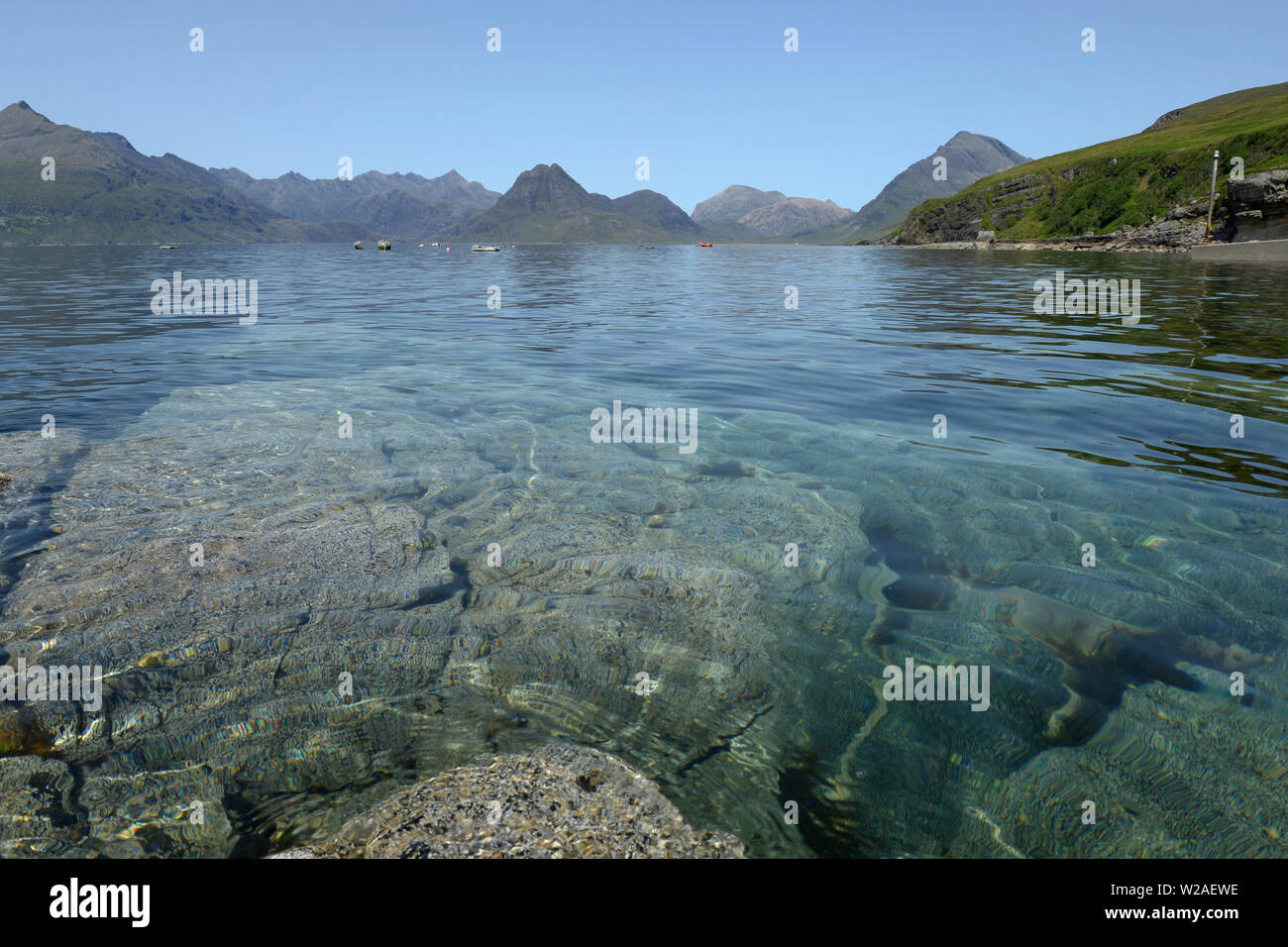 Clear turquoise water with mountains plunging to the sea. View from Elgol over Loch Skavaig to the Cuillin Hills Stock Photo