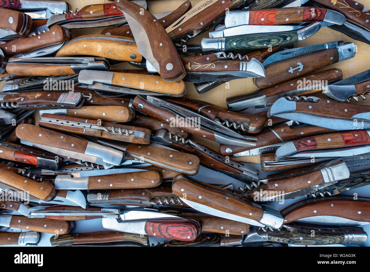 Large piles of Flick knives available and on sale in France market puce Stock Photo Alamy
