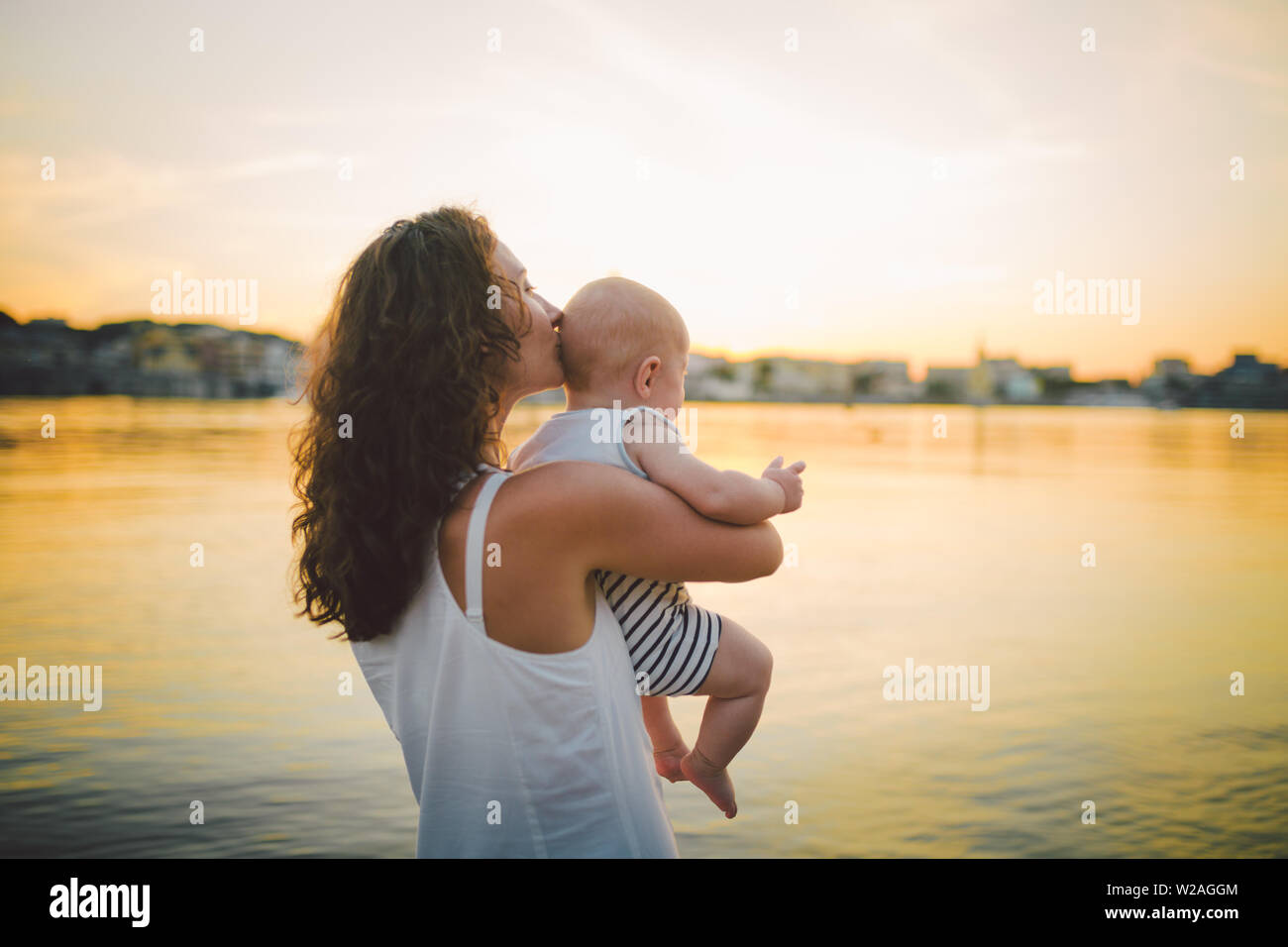 Close up of a mother carrying her baby boy hi-res stock photogra image