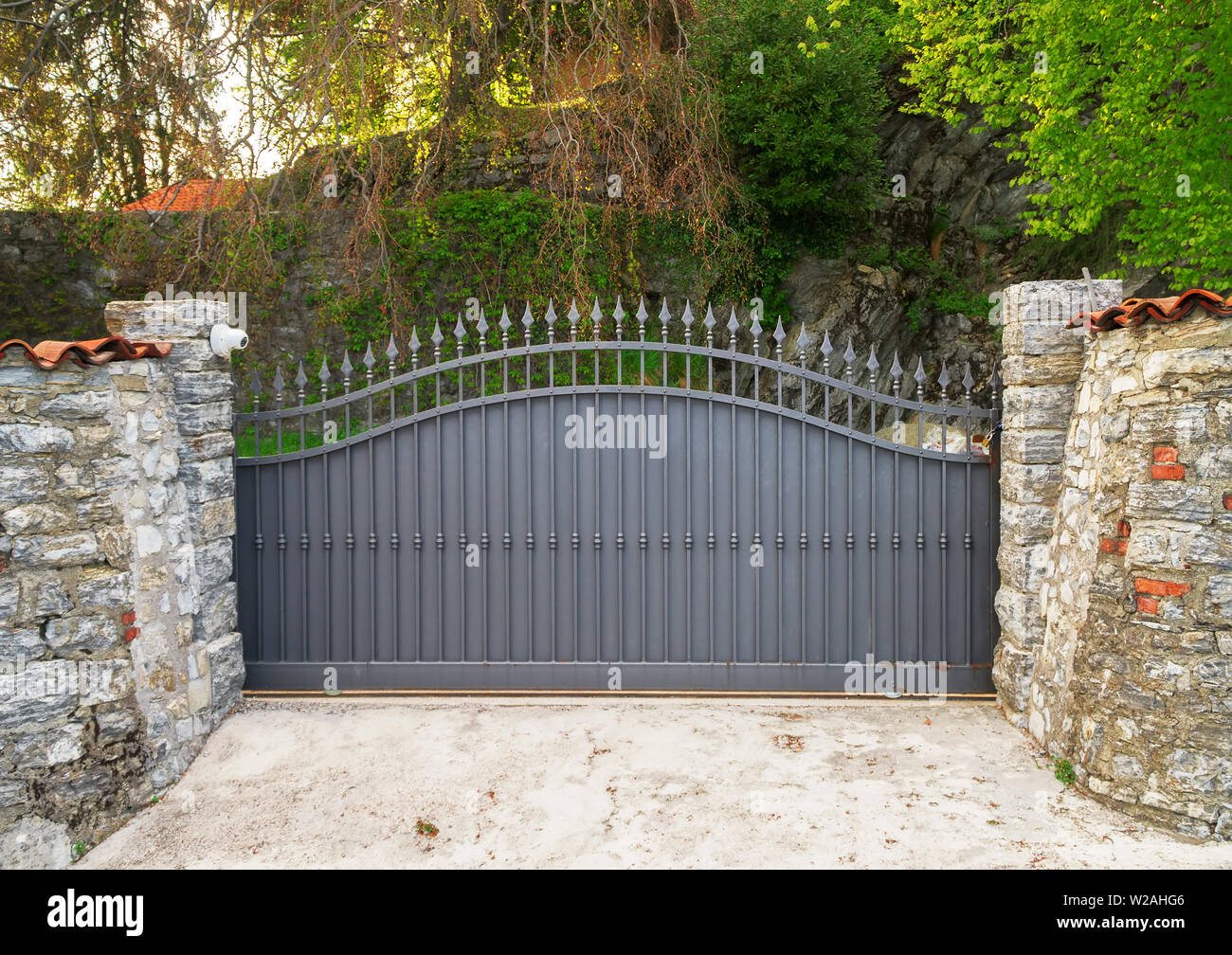 Metal gates and security camera. Concept of private property. Stock Photo