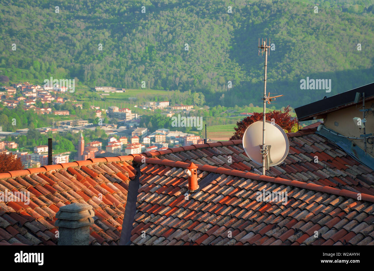 Antenna and satellite dish on the roof of the house. Stock Photo