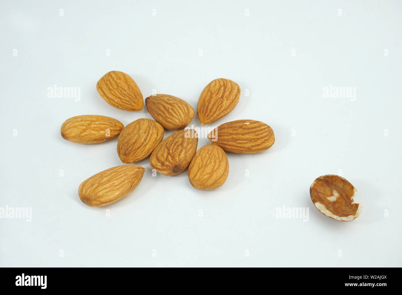 good and bad almonds isolated on white background Stock Photo