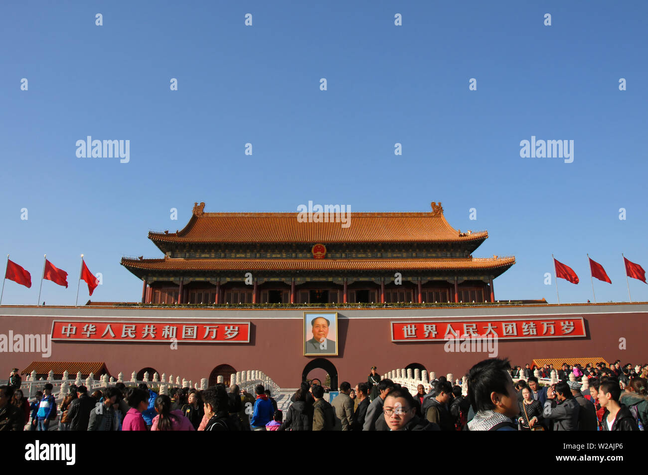 People in front of the Gate of Heavenly Peace in Tiananmen Square, Beijing, China. Tiananmen Square is a Beijing landmark visited by tourists. Stock Photo