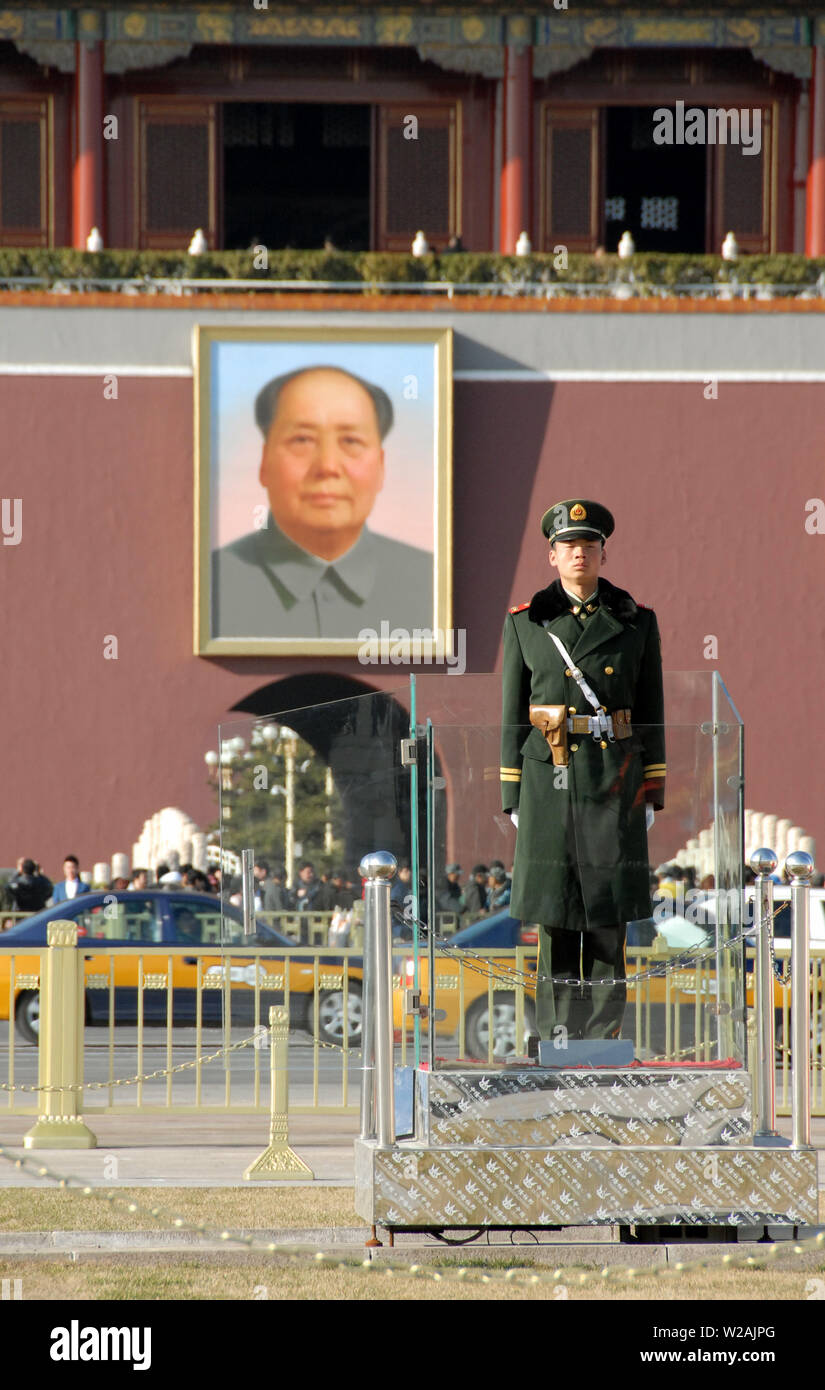 Guard standing in Tiananmen Square in front of the Gate of Heavenly Peace with a portrait of Mao Zedong (Chairman Mao). Tiananmen Square, Beijing. Stock Photo