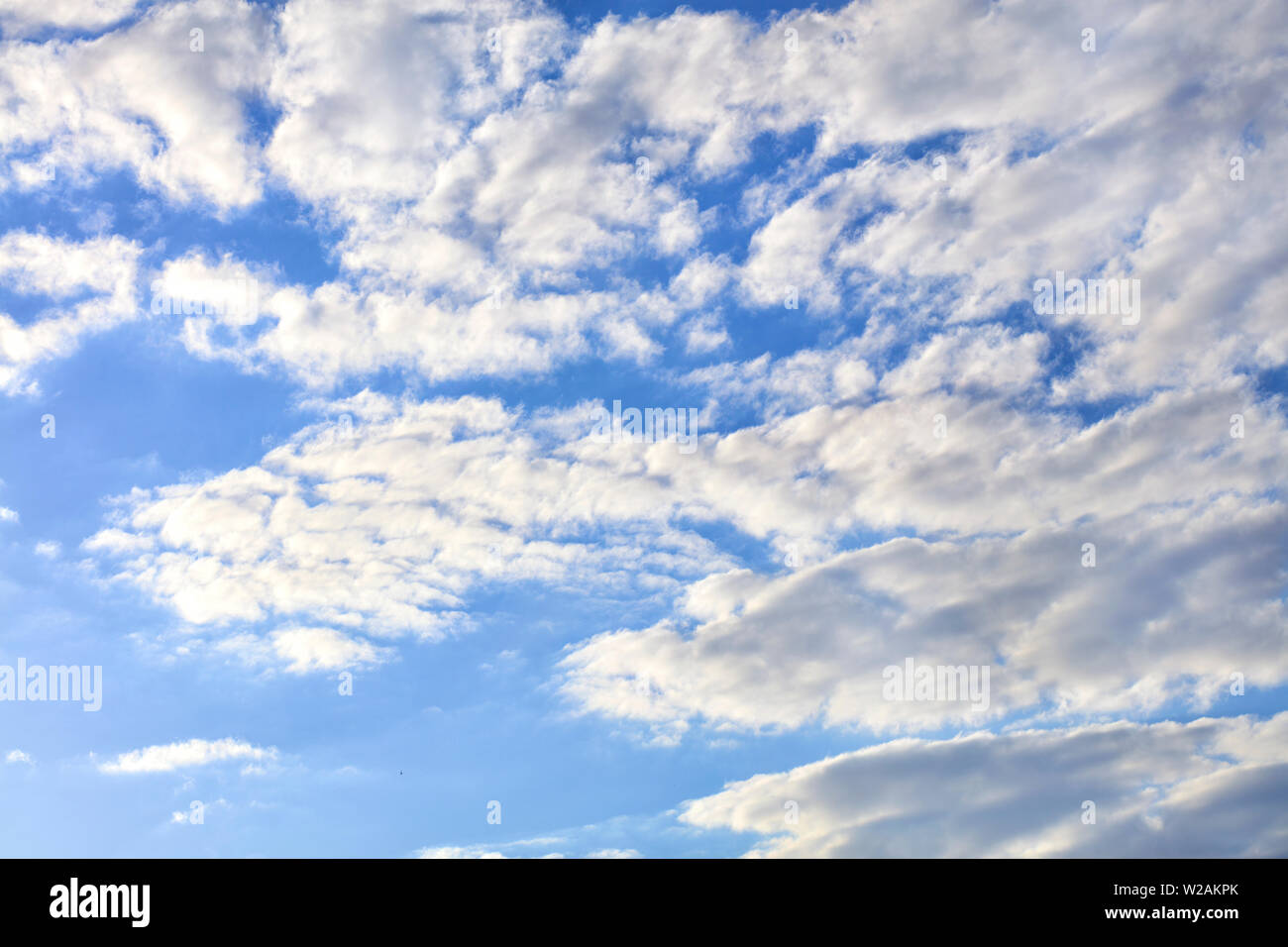 Light blue sky with white and gray fluffy clouds Stock Photo - Alamy