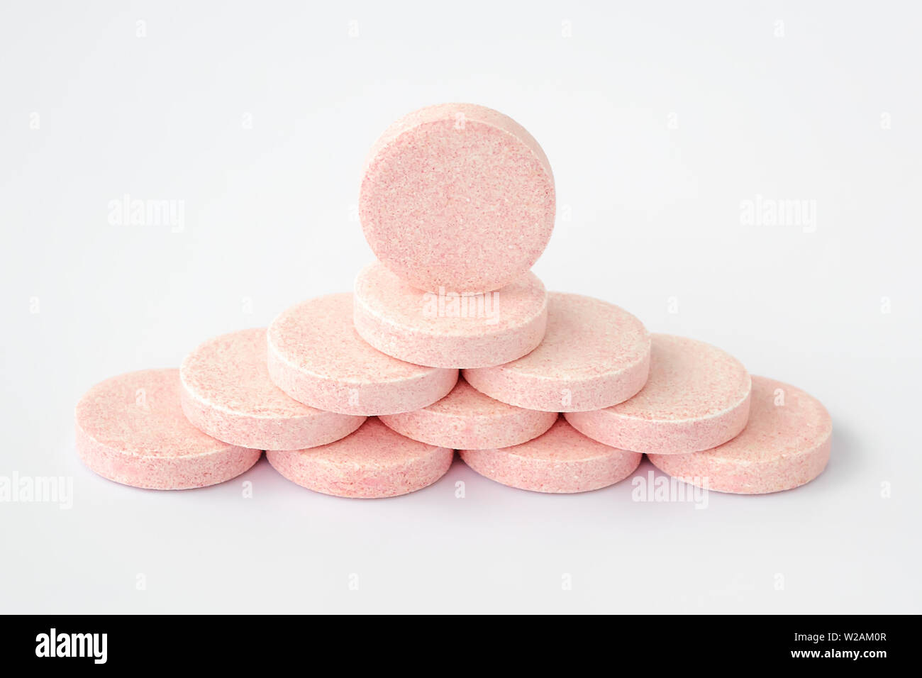 Pyramid of soluble effervescent vitamin tablets on a white background ...