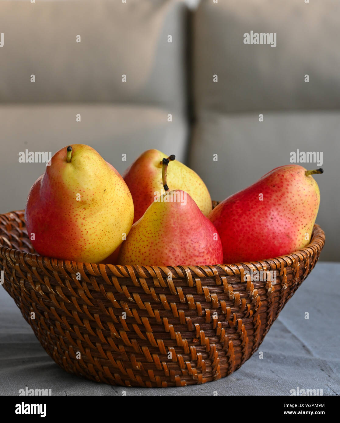 Close up of red and yellow pears in basket Stock Photo