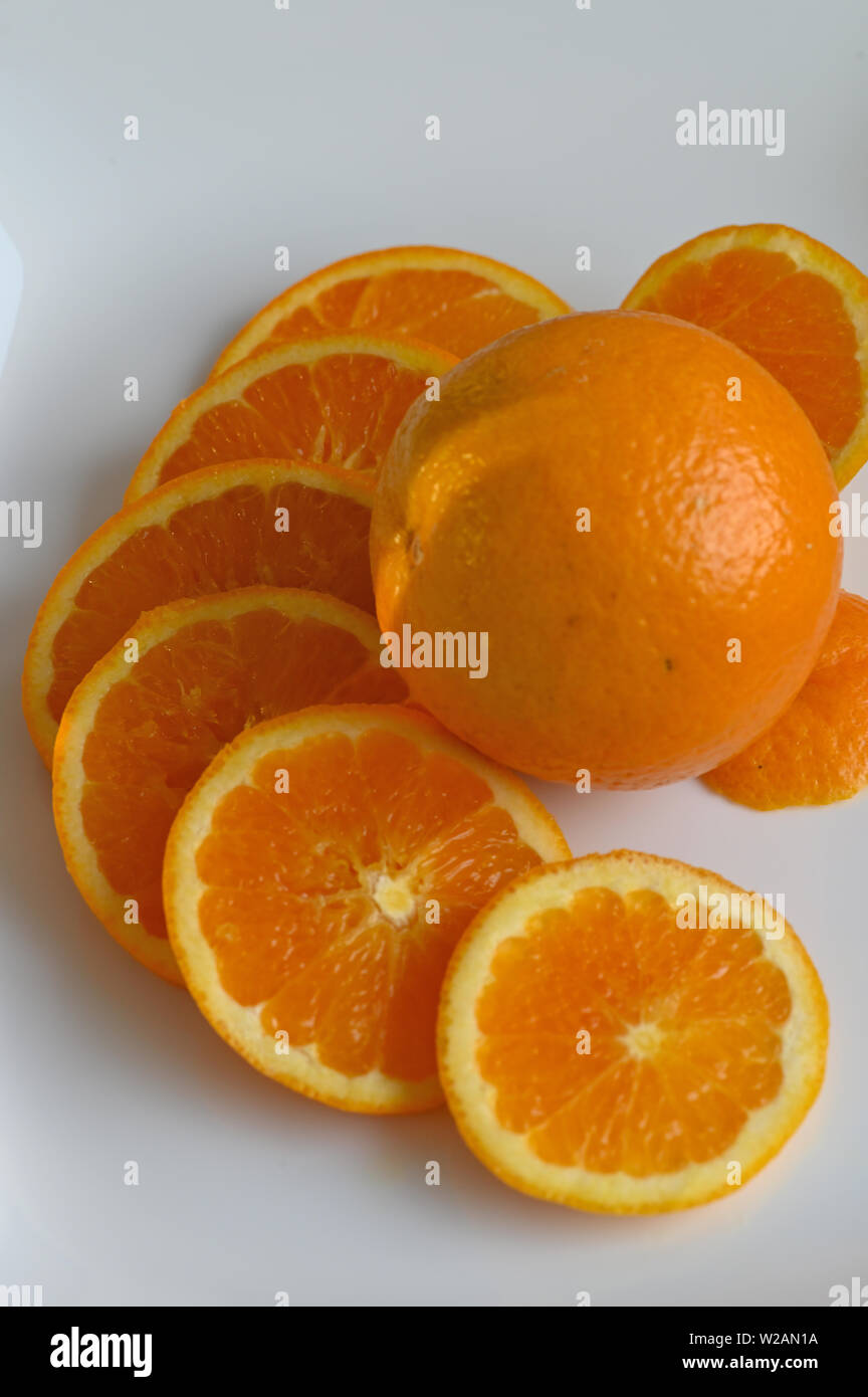 Close up of Orange slices on white plate Stock Photo