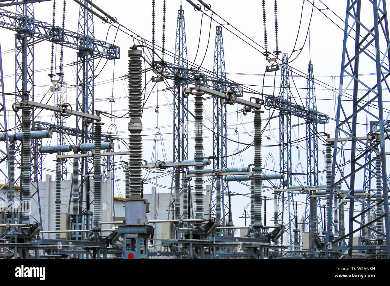 Steel masts of high voltage power lines at the plant. Electrical substation, power converter