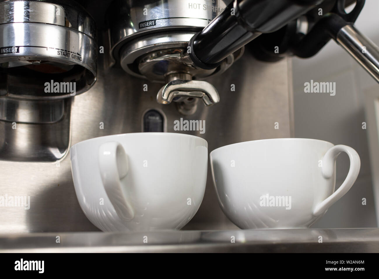 Coffee Machine Extracting Coffee into Two Cups Stock Photo