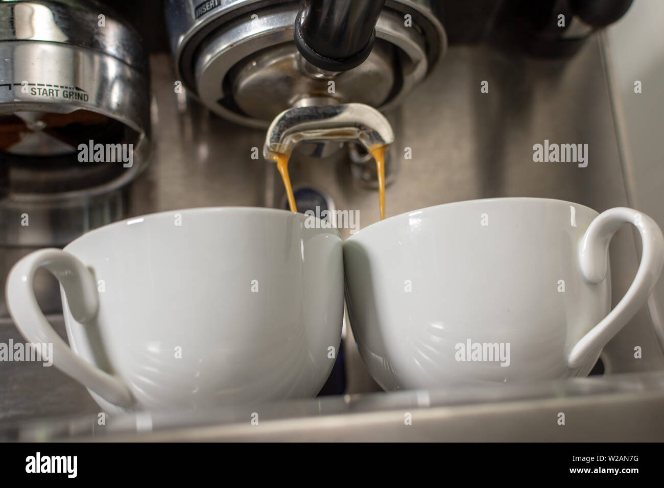 Coffee Machine Extracting Coffee into Two Cups Stock Photo